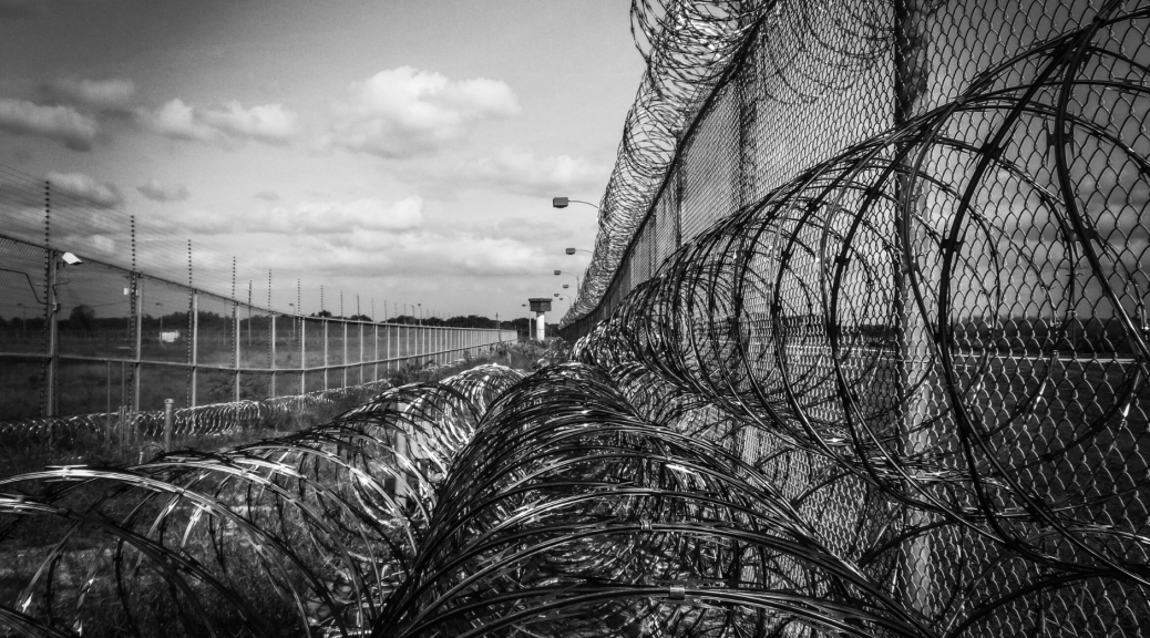 rhetoric and policies too often silence the voices of justice--this image highlights that with an image of a barbed-wire fence