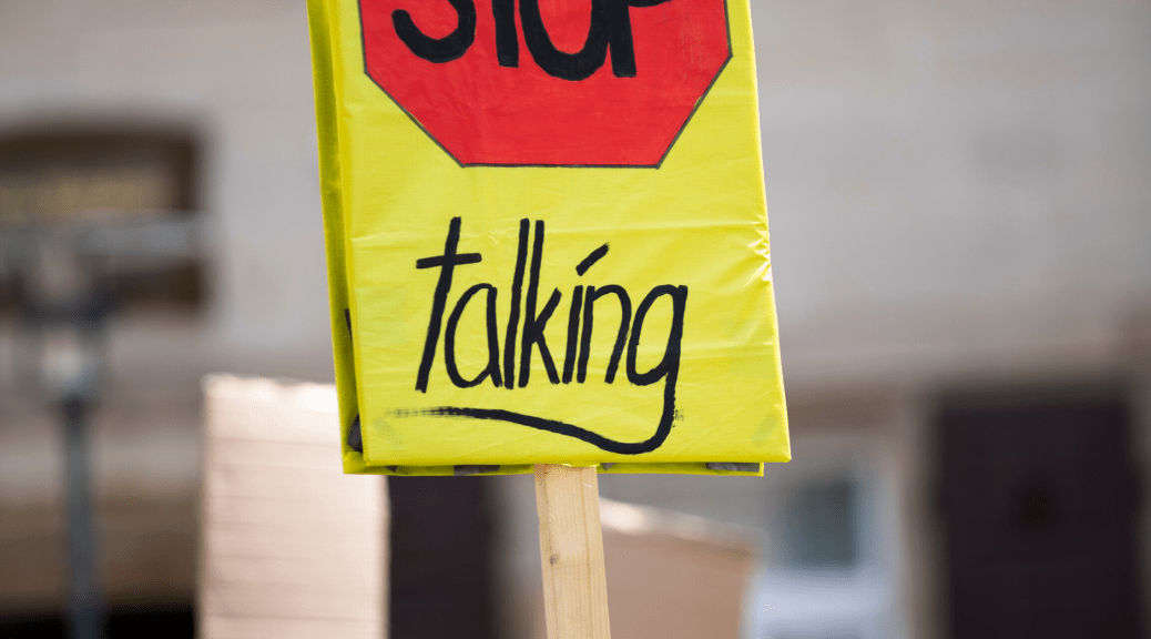 Toward Healthy Dissent (Person Holding a Sign that says "Stop Talking")