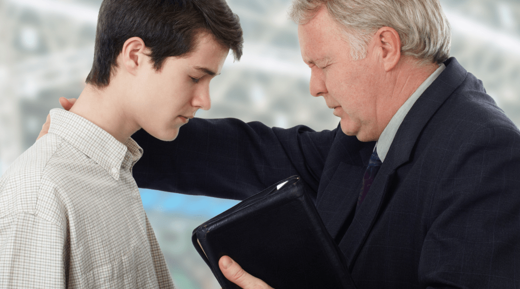 A photo of a white man evangelizing a young man--introduces an article analyzing the demonization of critical race theory