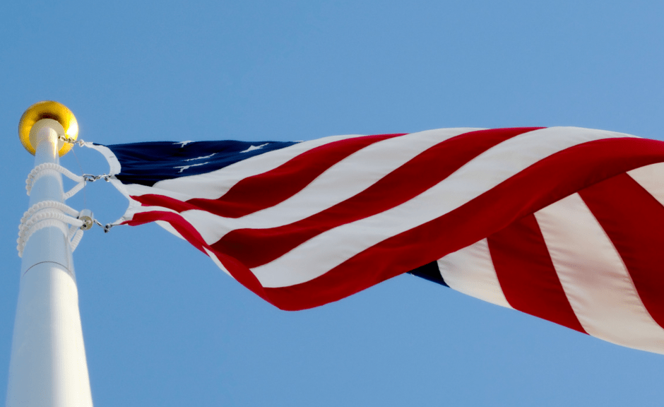 US flag on a pole to discuss K-12 as a right-wing educational battleground