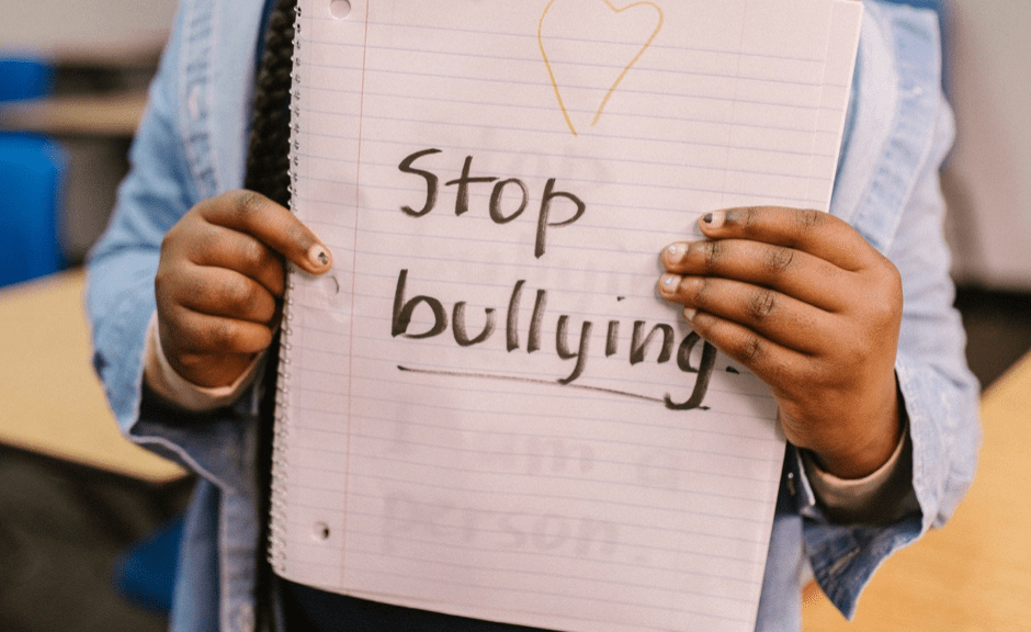 Girl Holding "Stop Bullying" sign to introduce a post on assertiveness in an age of Herod(s)