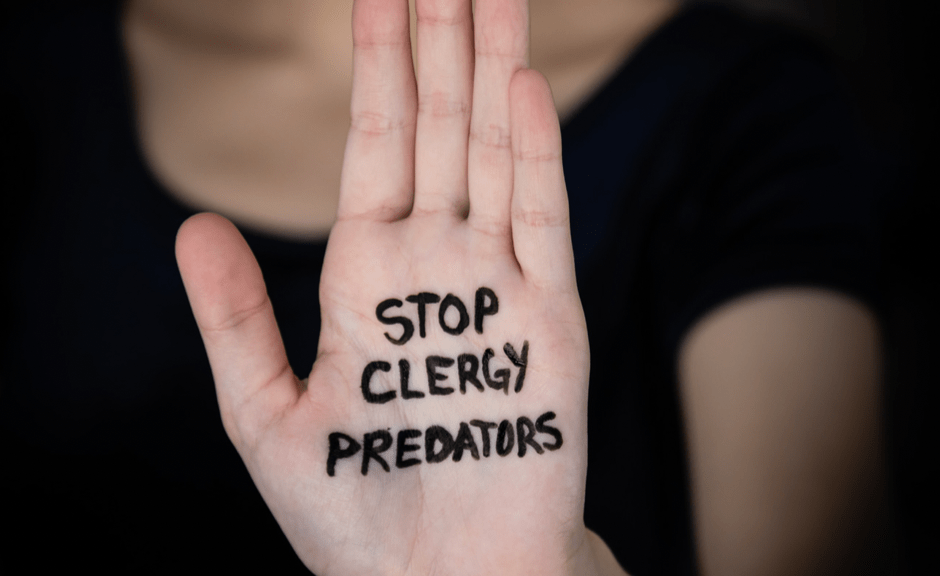 A hand on which is written Stop Clergy Predators to introduce an article reading the Gospel of Mark as against clergy abuse