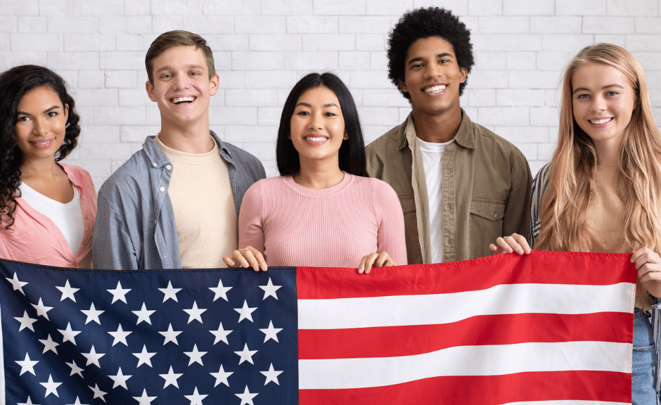 Immigrants standing behind a flag to introduce a blog post on how right-wing immigration rhetoric is fascistic and harmful