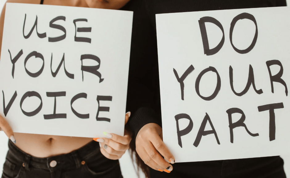 Image of two people holding signs saying "use your voice" and "do your part" to introduce a blog post encouraging reasonable people to avoid cynicism and hopelessness